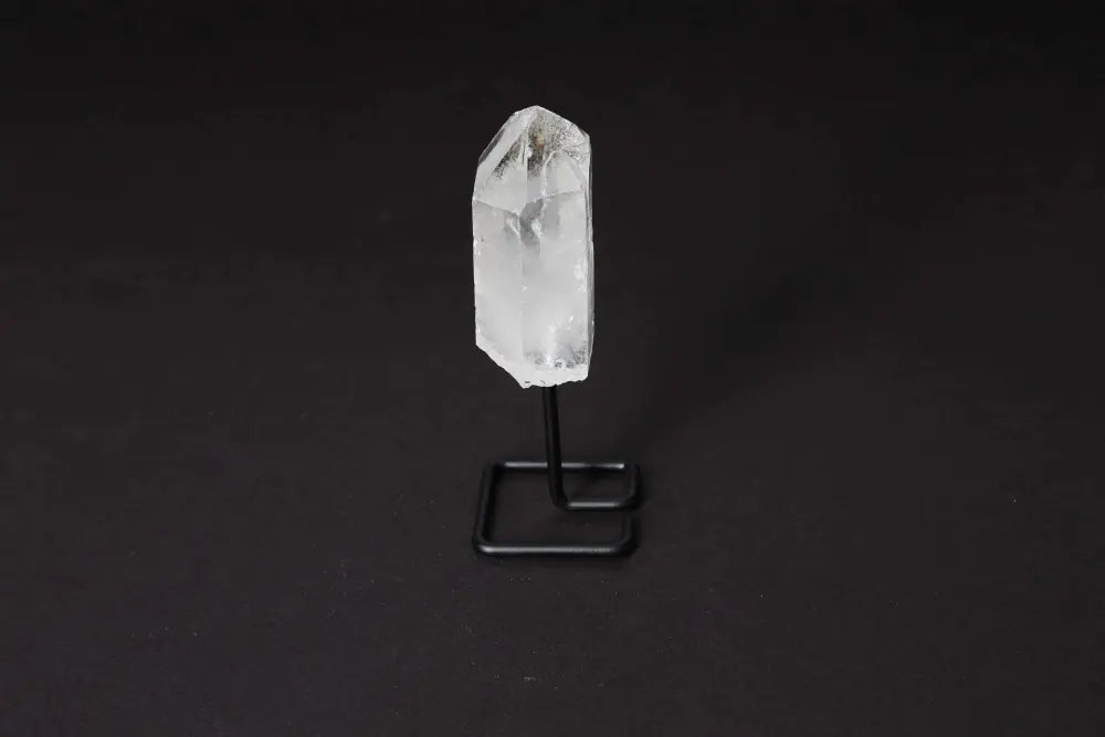Natural clear quartz point on modern stand, ideal for amplifying energy, clarity, and focus. Perfect centerpiece for meditation.