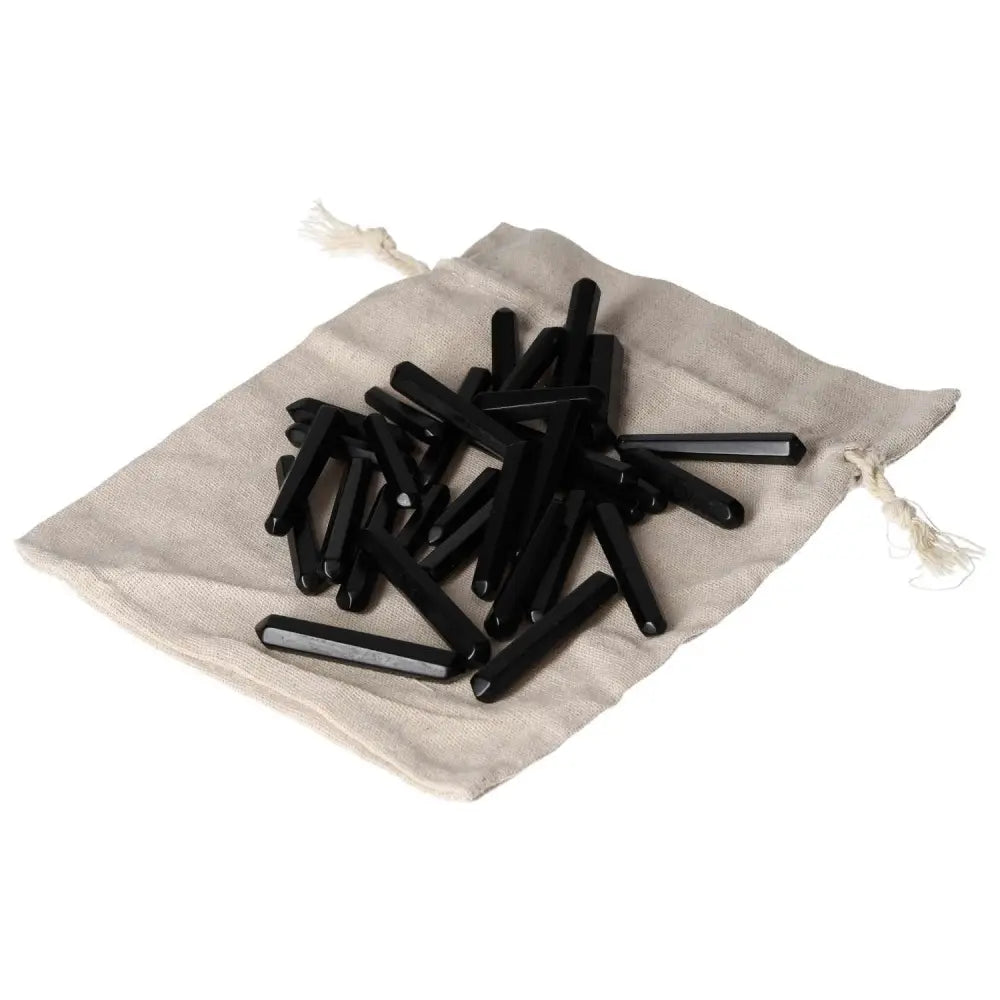 Obsidian Small Stics on a drawstring bag, known for protective aura and negative energy absorption, enhancing personal defense.