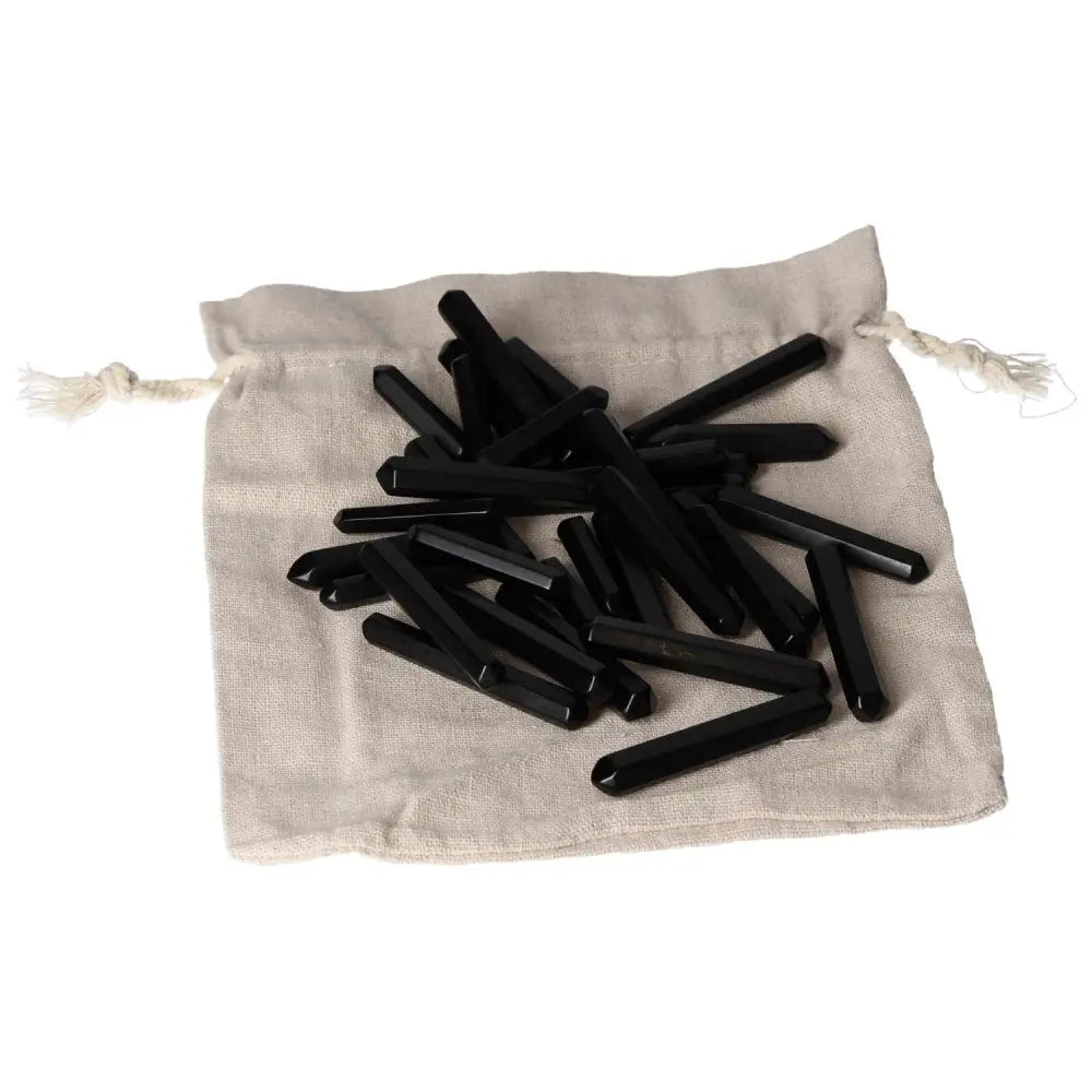 Obsidian Small Stics on a drawstring bag, known for powerful protective aura and negative energy absorption.