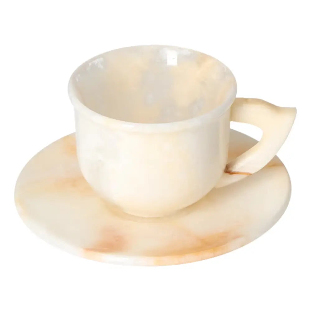 Luxurious off-white onyx coffee cup with matching plate, showcasing elegant natural patterns and a soft polished finish.