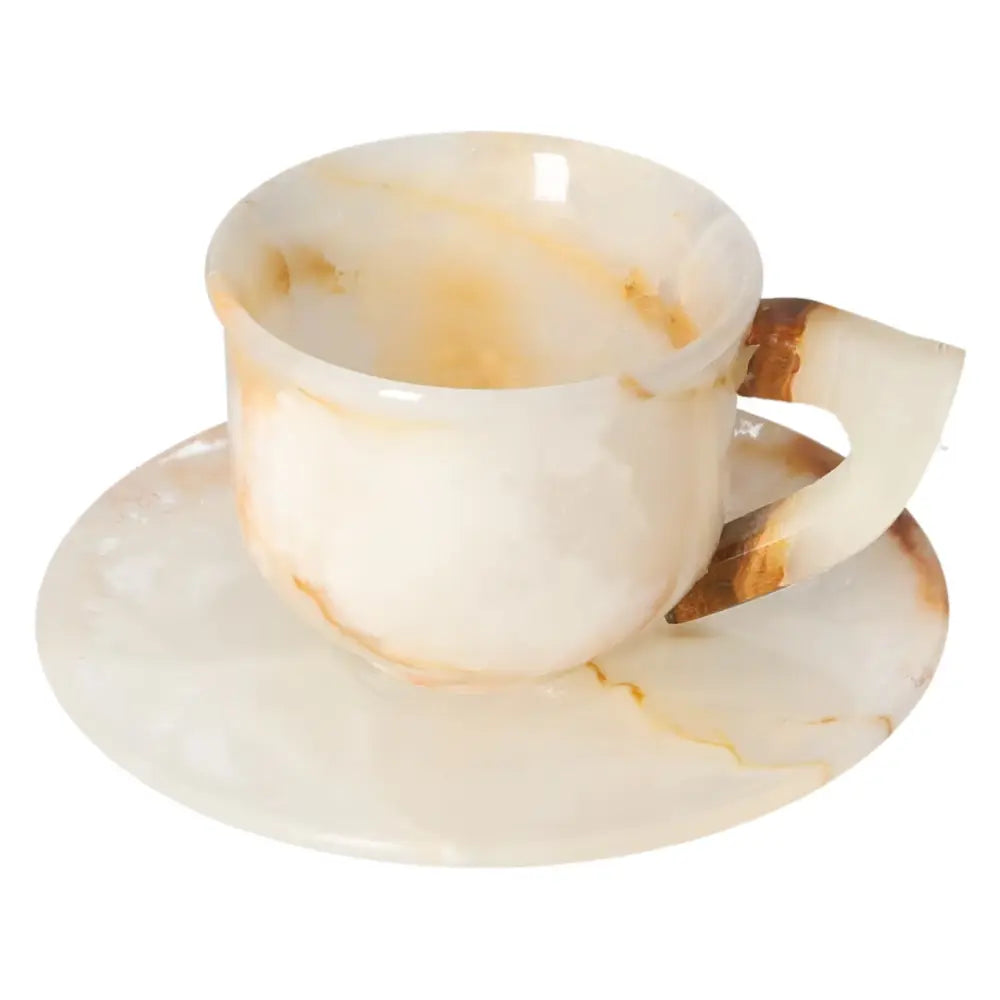 Elegant off-white onyx coffee cup and plate set, showcasing unique patterns, polished to a smooth finish, reflecting ambient light.