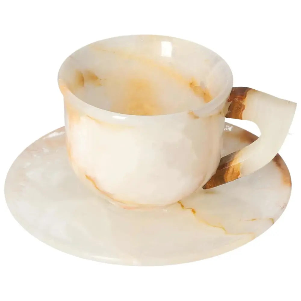 Exquisite off-white onyx coffee cup and plate with unique natural variations, enhancing elegance and beauty in any space.