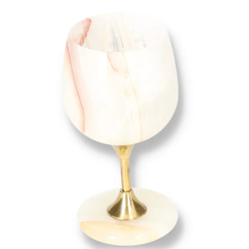 Exquisite onyx wine glass with polished surface and unique veining, featuring a gold stem and base for elegant fine drinking experiences.