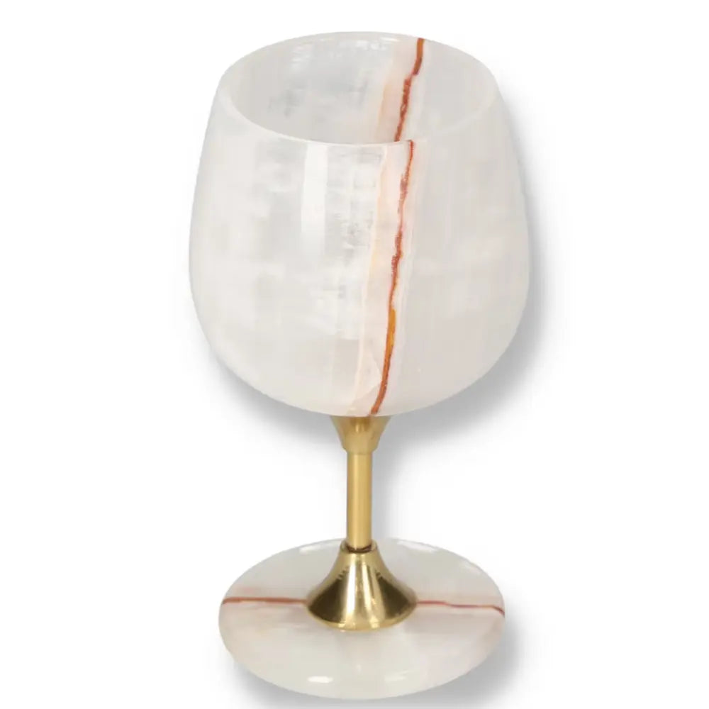 Elegant onyx wine glass with gold stem, featuring unique off-white color and natural veining patterns, perfect for sophisticated occasions.