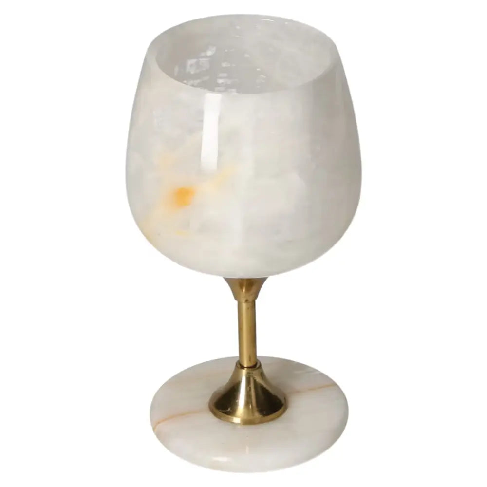 Off-white onyx wine glass with natural veining and elegant stem design, showcasing a sophisticated polished look.