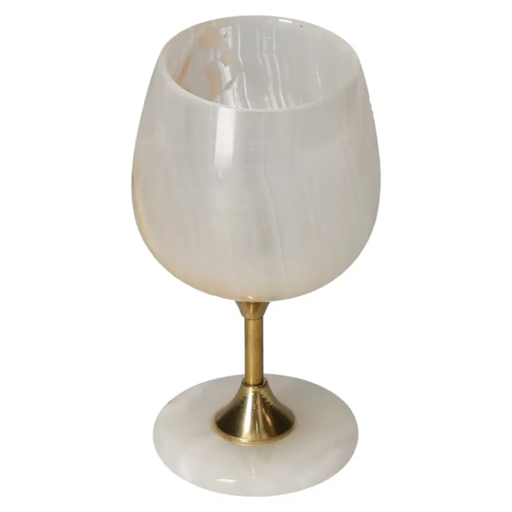 Elegantly crafted onyx wine glass with unique color variations and gold-toned stem, perfect for sophisticated dining experiences.