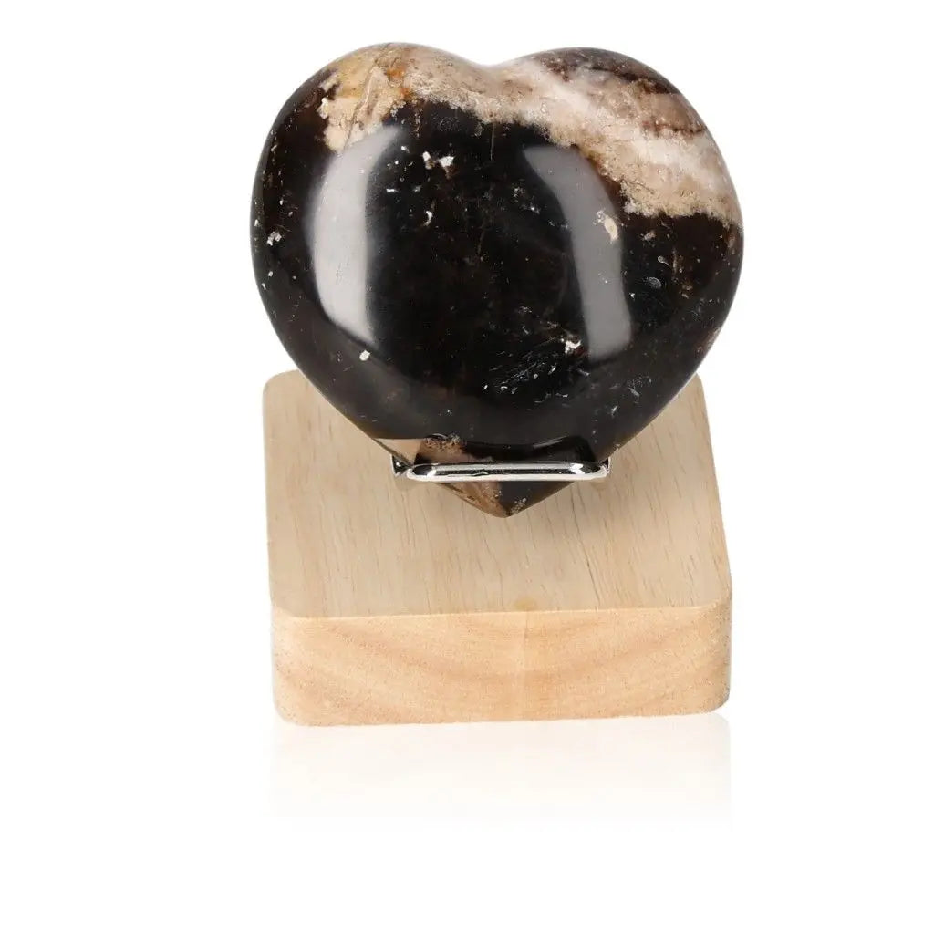 Heart-shaped Opal Verte crystal displayed on a wood stand, known for inspiring love, passion, and cosmic consciousness.