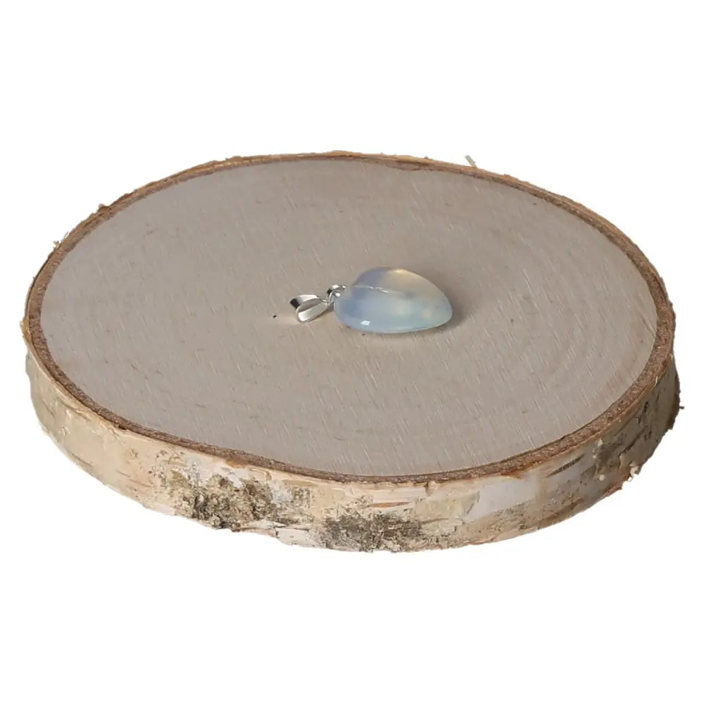 Opallite Heart Pendant 15mm on rustic wood, showcasing iridescent glow and elegant design by Sylvia Crystals.