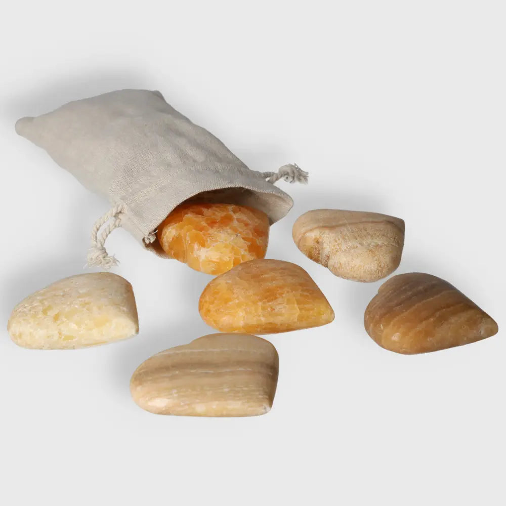 Orange Calcite Heart gemstone set with pouch, symbolizing love and creativity. Ideal for crystal enthusiasts and as a heartfelt gift.