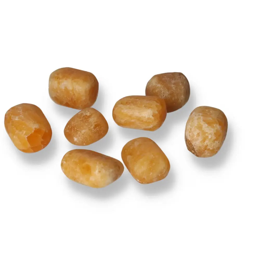 Tumbled orange calcite stones for positivity and emotional healing, showcasing vibrant hues of orange and cream.