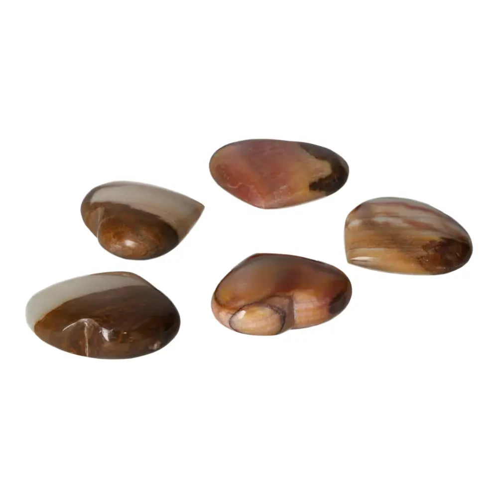 Five polished peach calcite heart-shaped stones on a white background, symbolizing love and emotional renewal.