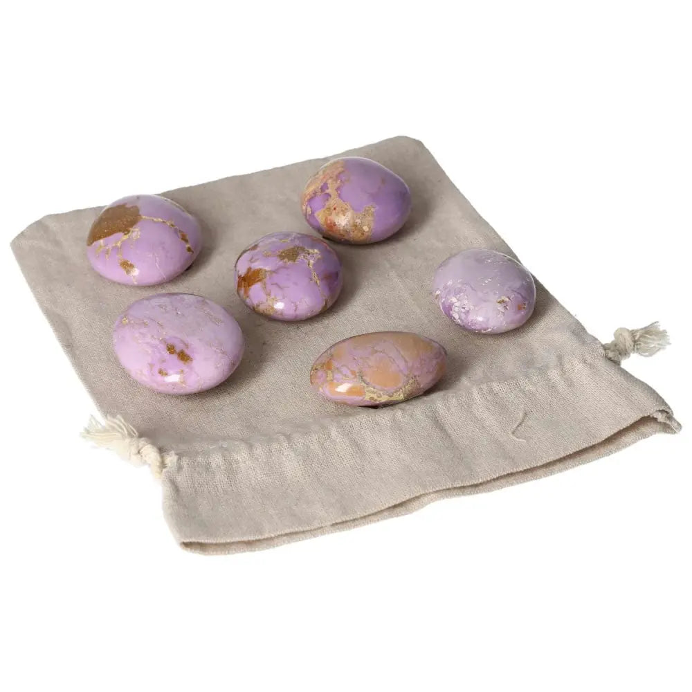 Collection of Phosphosidente Palmstones on a beige cloth pouch.