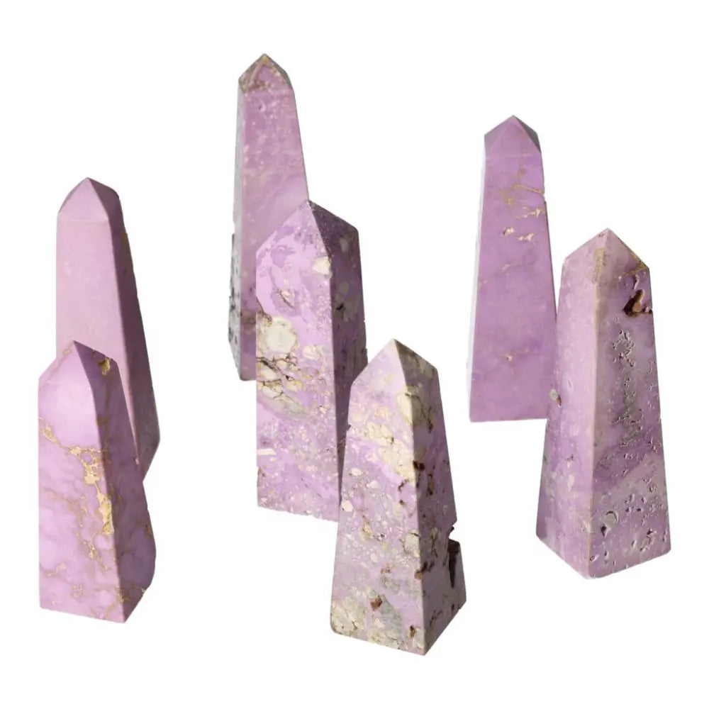 Six polished purple crystal towers with natural mineral patterns, ideal for home decor or spiritual practices.