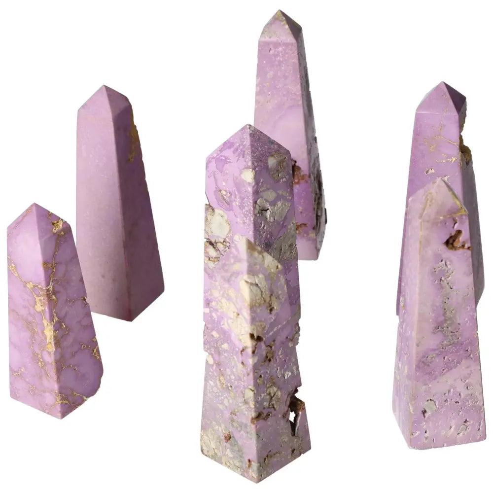 Set of five purple crystal towers with unique gold veining, perfect for decorative purposes and spiritual energy enhancement.