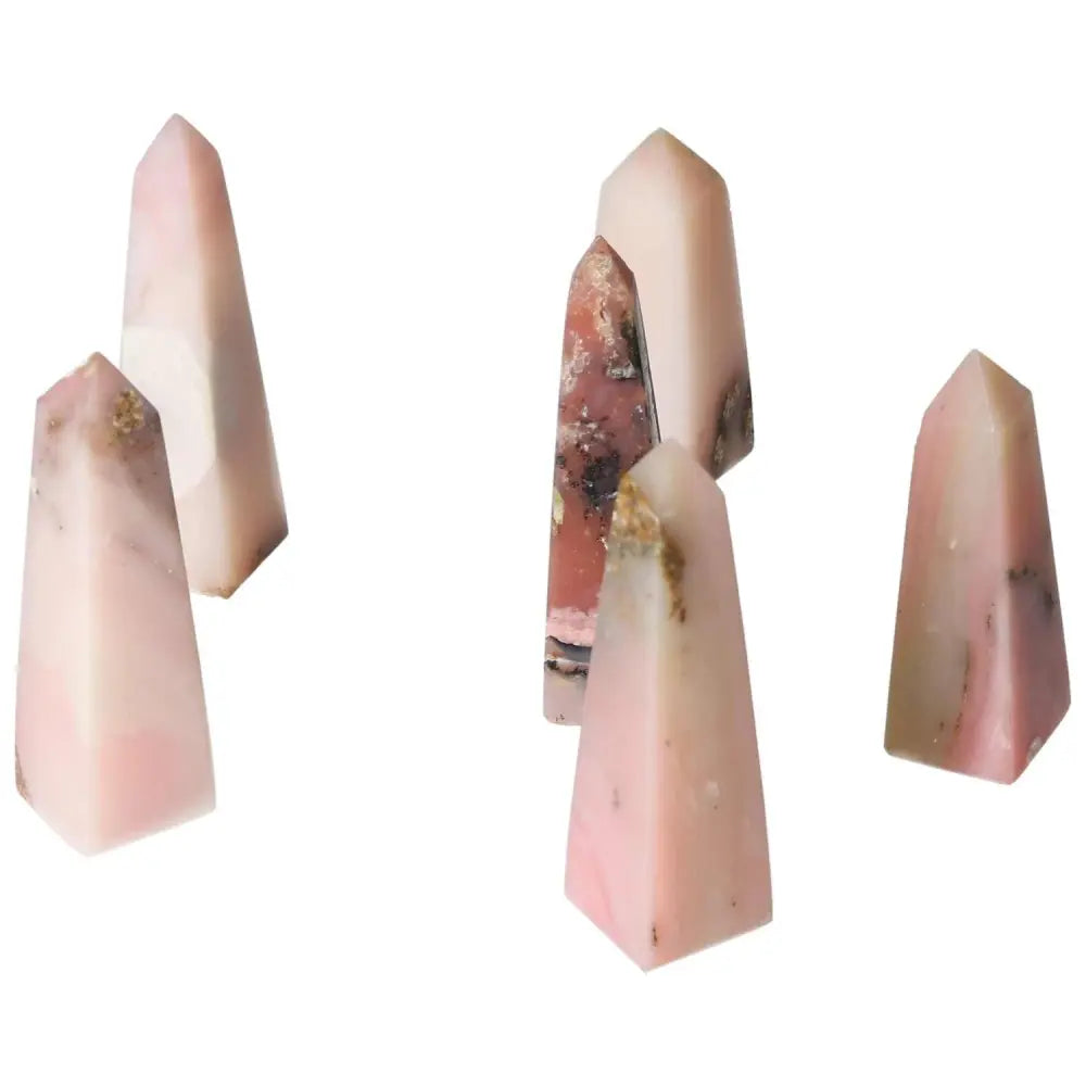 Pink Opal towers displaying pastel pink hues, opalescent sheen, and smooth texture, ideal for emotional healing and personal transformation.