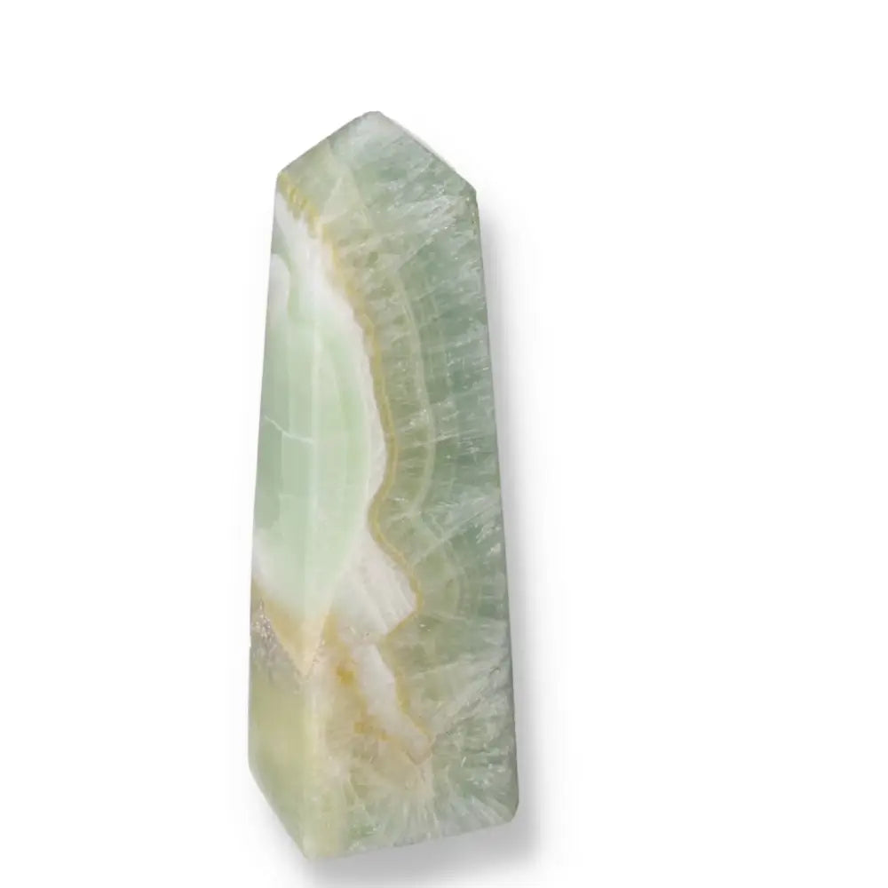 Pistachio Calcite Tower crystal with soothing green hues, promoting calm and renewal through its natural beauty and metaphysical properties.