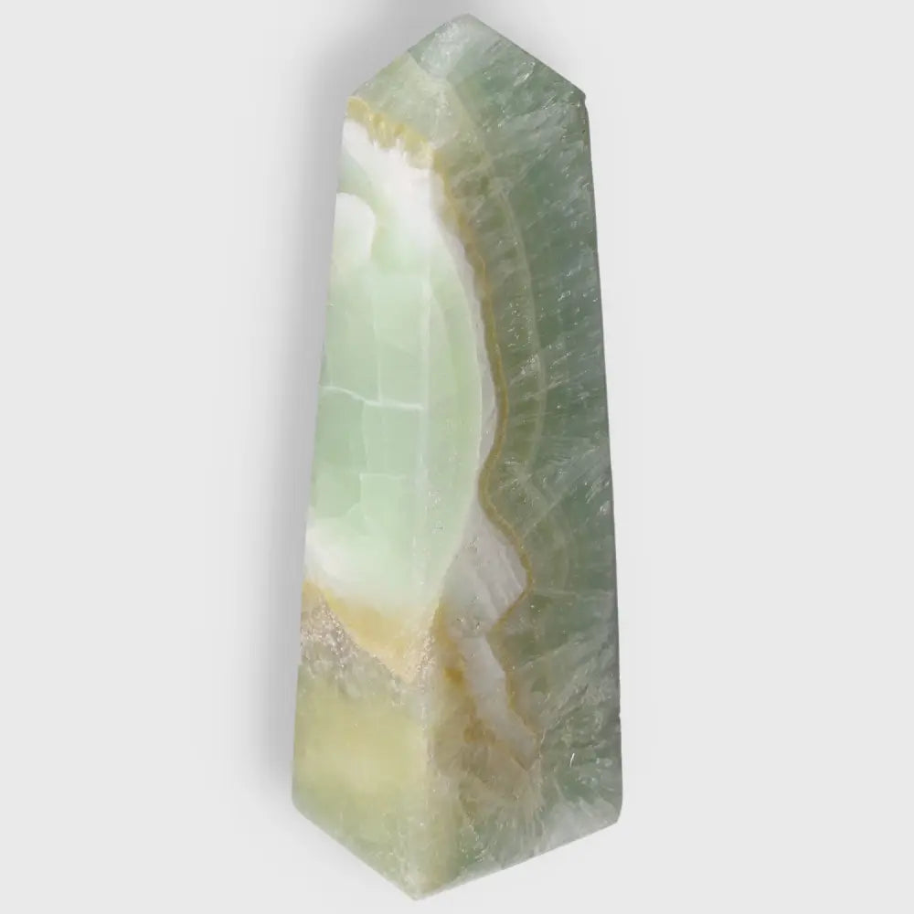 Pistachio Calcite Tower crystal with pale green hues and natural artistry for balance and harmony in your space.