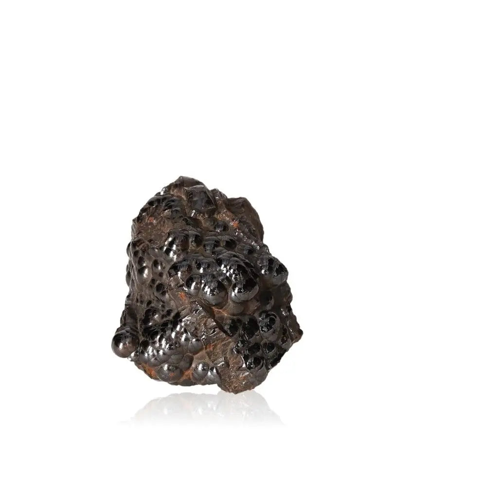 Polished botryoidal hematite crystal cluster against white background, showcasing its shiny, metallic surface and natural formation.