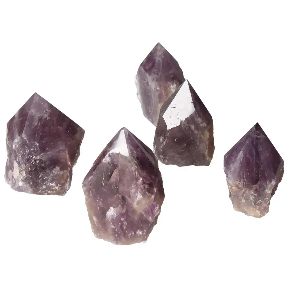 Five polished point amethyst crystals from Sylvia Crystals, known for stress reduction and energy enhancement.