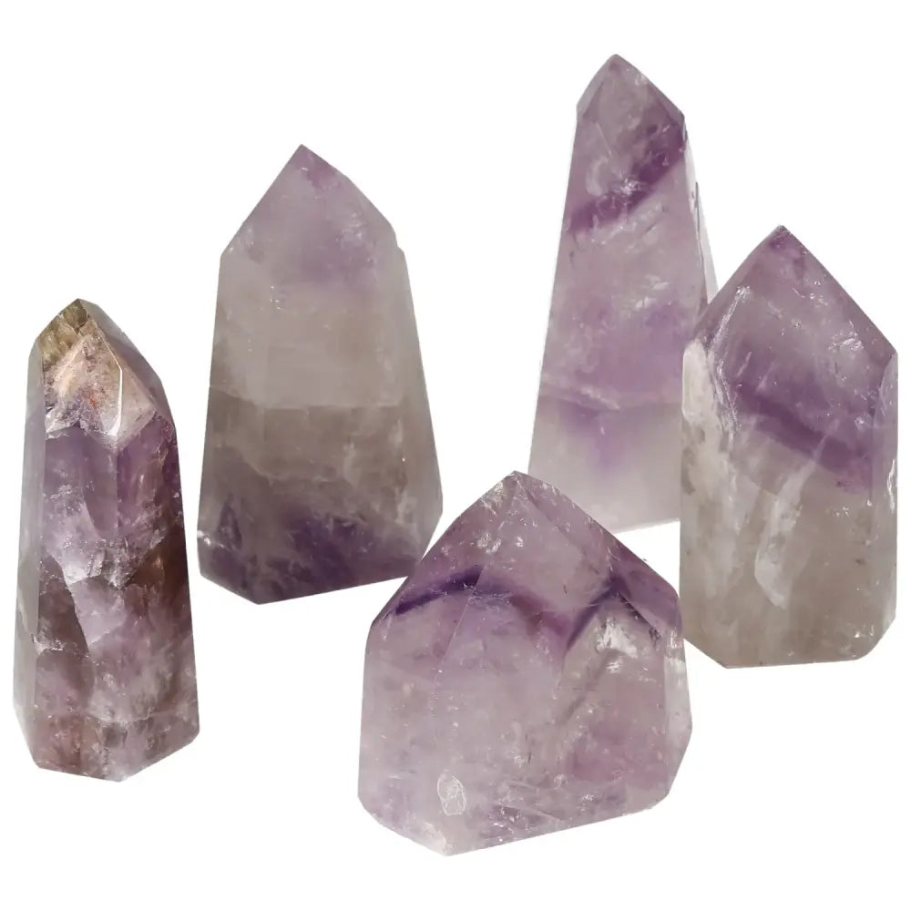 Polished Point Amethyst crystals by Sylvia Crystals, promoting tranquility and mental clarity, shown in varied sizes.