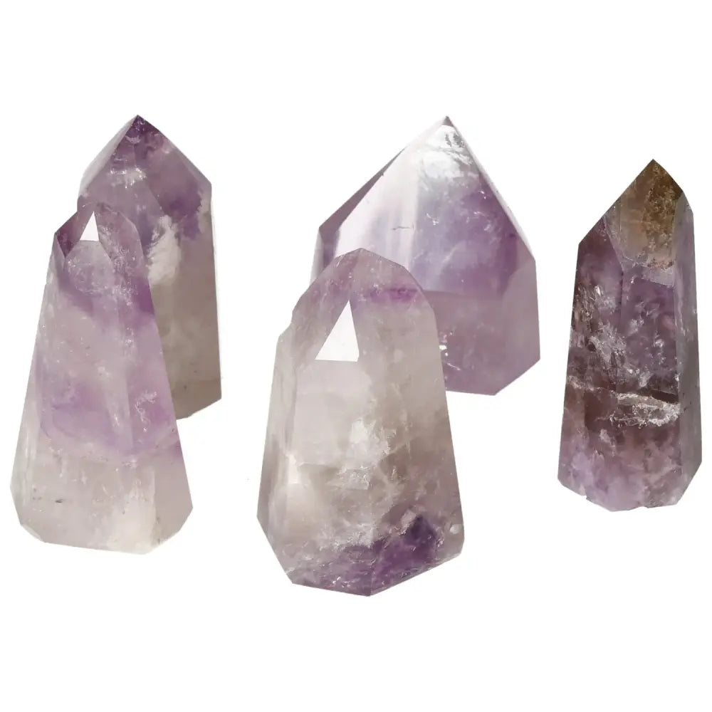 Collection of polished point amethyst crystals by Sylvia Crystals, enhancing tranquility and mental clarity, displayed on a white background.