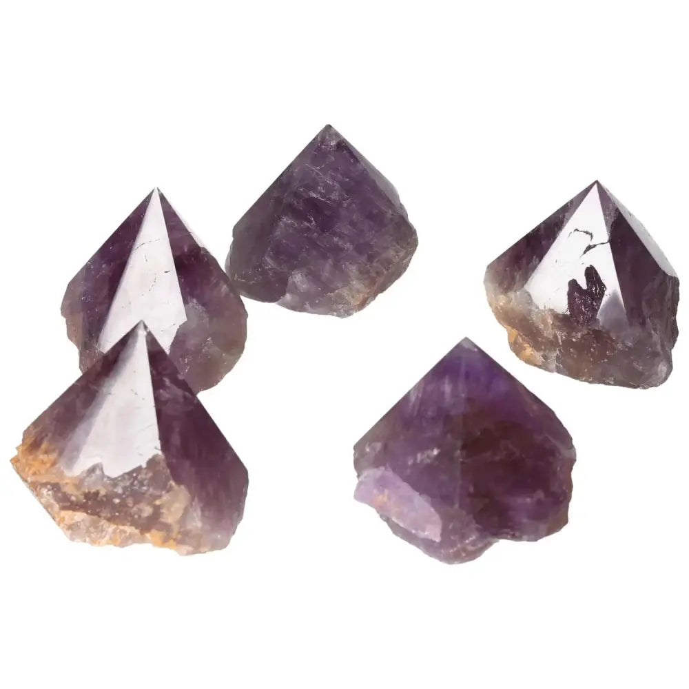 Five polished point amethyst crystals, showcasing deep purple hues and reflective surfaces, perfect for enhancing well-being and space energy.