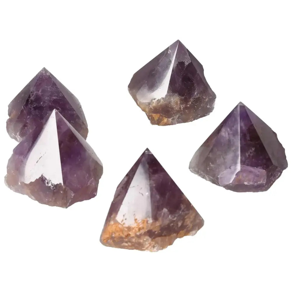 Five polished point amethyst crystals from Sylvia Crystals, showcasing luxury and energy enhancement for well-being.