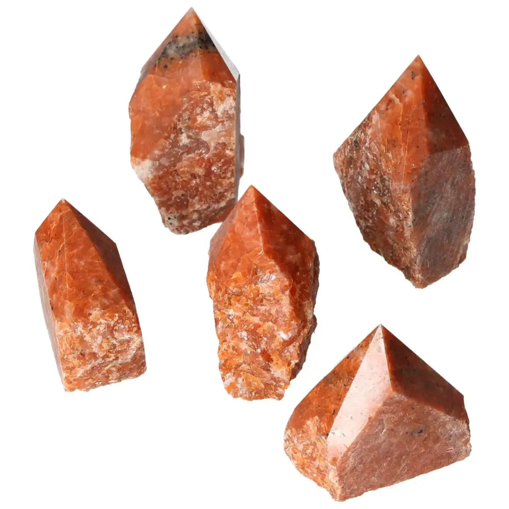 Polished Point Calcite M crystals with fiery tones from Sylvia Crystals, symbolizing willpower and personal transformation.