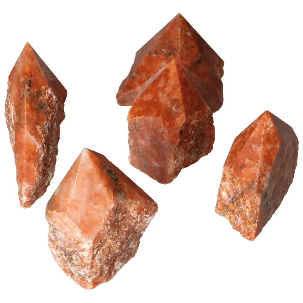 Polished Point Calcite M crystals displaying fiery tones and unique shapes, symbolizing vitality and transformation from Sylvia Crystals.
