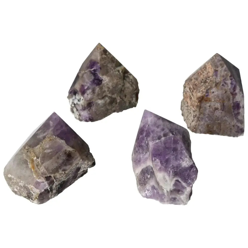 Four polished chevron amethyst points showcasing natural purple and white patterns, ideal for crystal enthusiasts and collectors.