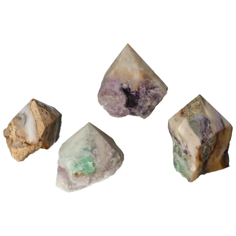 Assorted polished fluorite crystal points showcasing vibrant hues, ideal for enhancing mental faculties and personal growth by Sylvia Crystals.