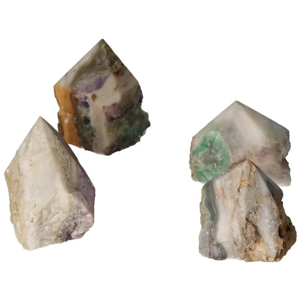 Four polished point Fluorite L gemstones from Sylvia Crystals, showcasing vibrant hues and unique formations for mental clarity and growth.
