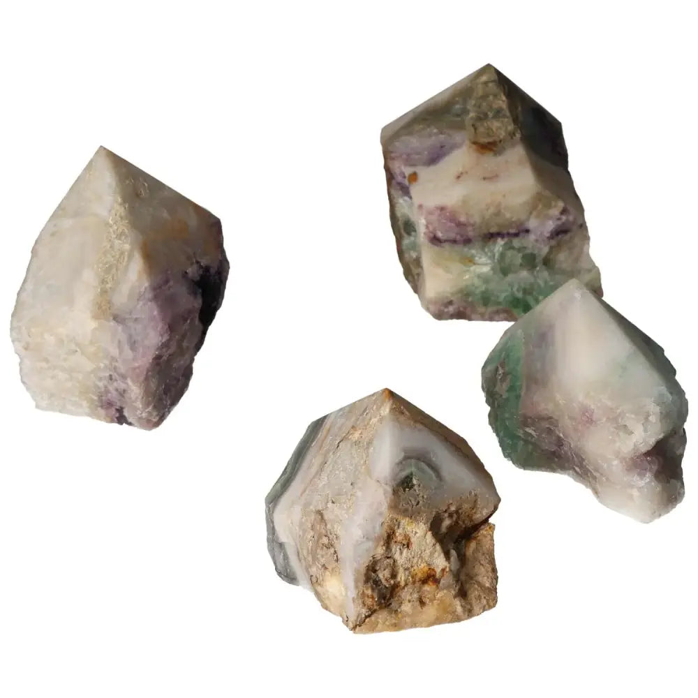 Four polished fluorite crystal points, showcasing vibrant hues and natural patterns, by Sylvia Crystals for mental enhancement and growth.