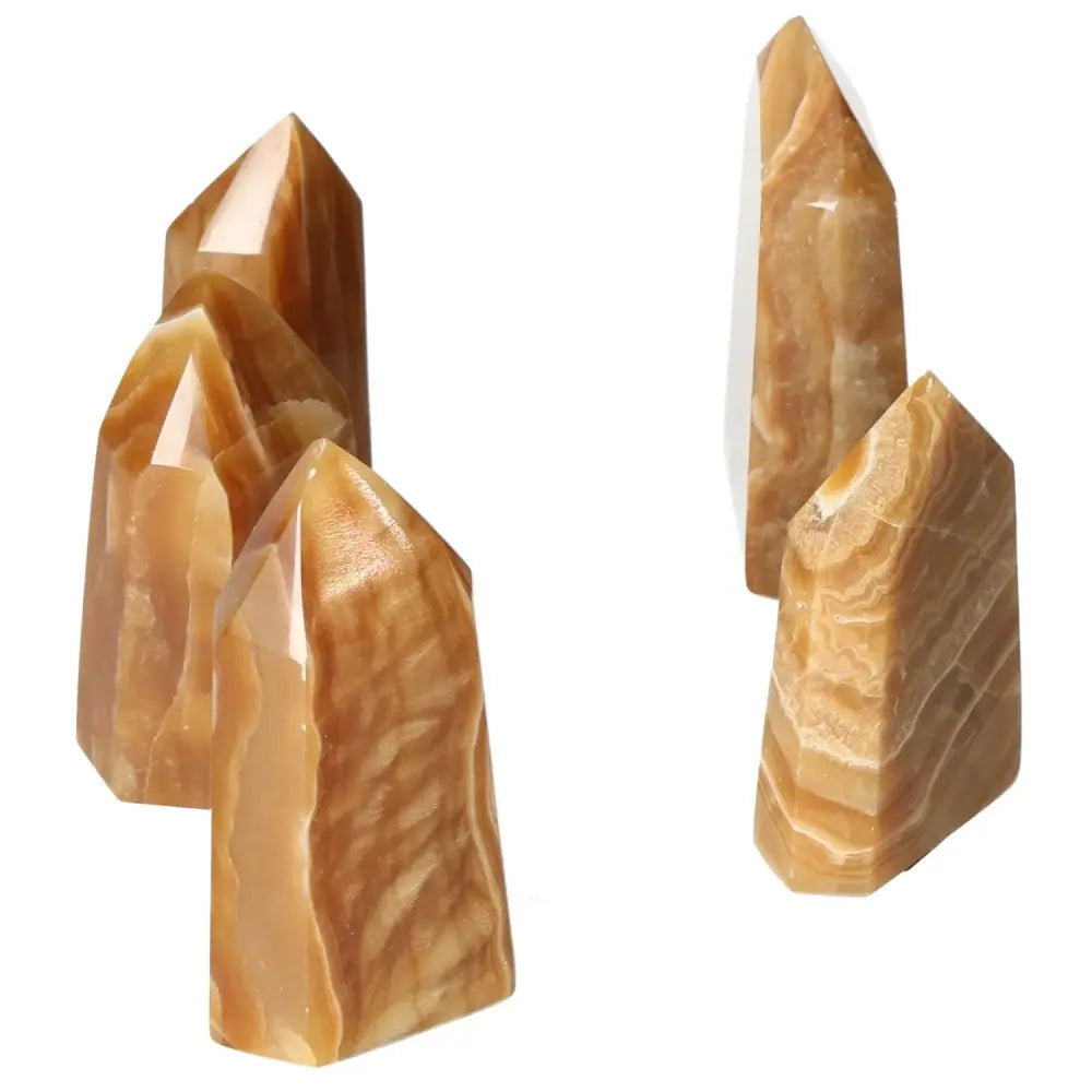 Polished Point Honey Calcite M crystals with rich honey hues, promoting prosperity and emotional healing from Sylvia Crystals.