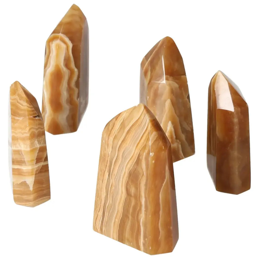 Polished Point Honey Calcite M crystals with rich honey hues, symbolizing prosperity and emotional healing, from Sylvia Crystals.