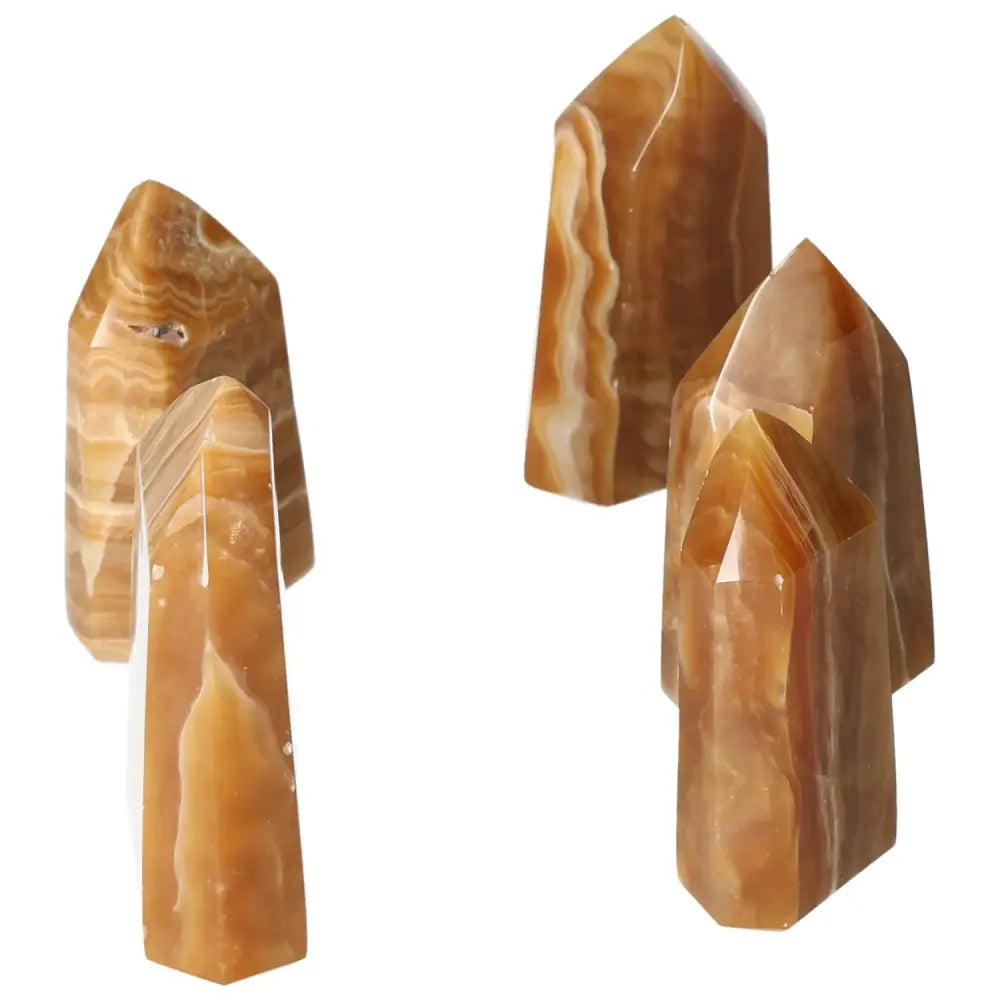 Polished Point Honey Calcite M crystals showcasing rich honey-like hues, symbolizing prosperity and emotional healing from Sylvia Crystals.