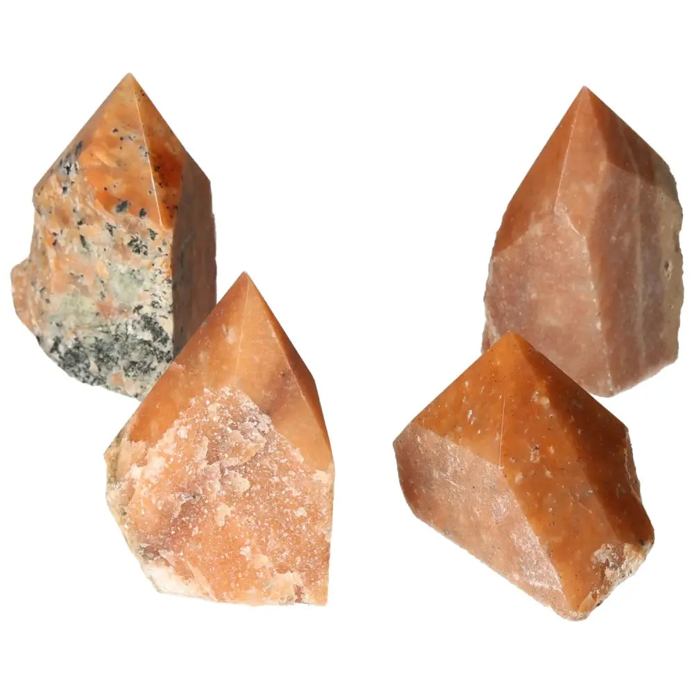 Four polished orange calcite bi-color crystals showcasing unique patterns and hues, perfect for enhancing any space with luxury and harmony.