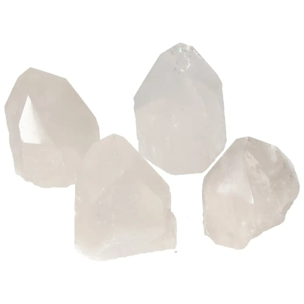 Four polished point quartz crystals from Sylvia Crystals, ideal for energy alignment and chakra enhancement.