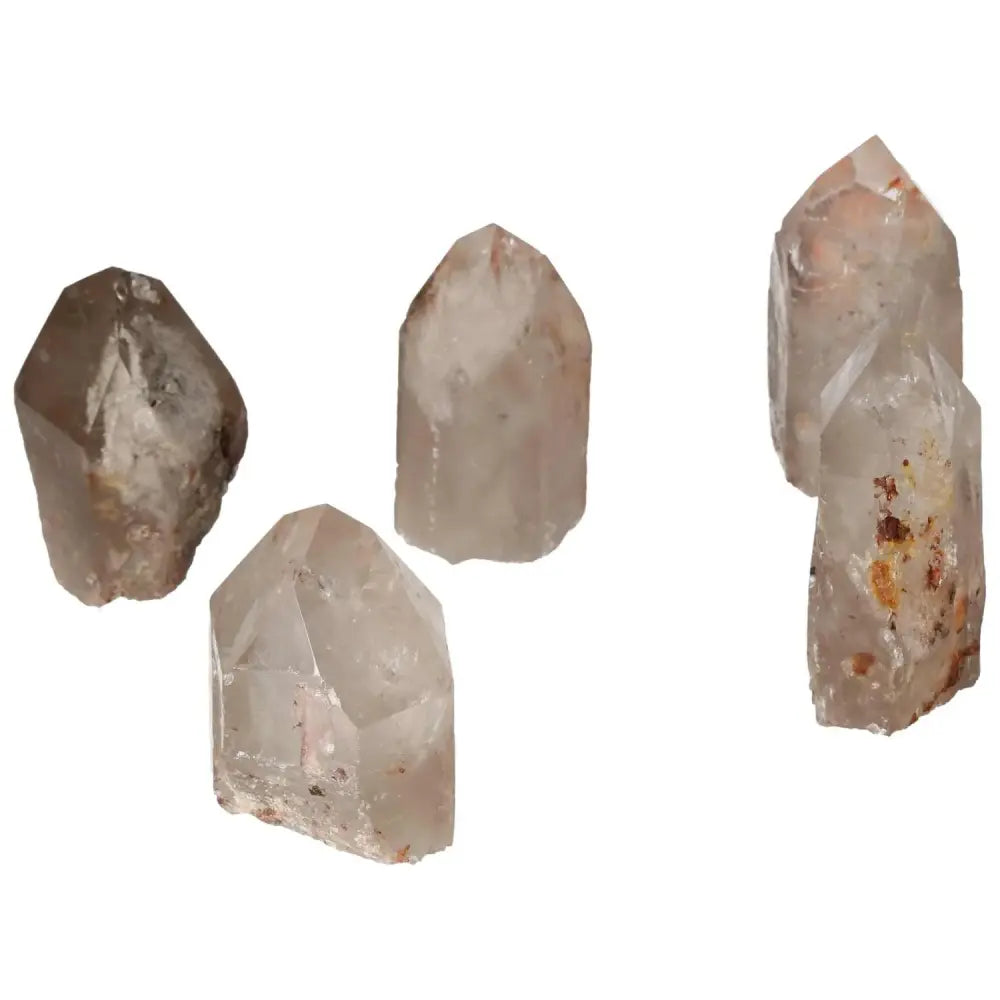 Five polished point quartz crystals with hematite inclusions on a white background, highlighting their unique formations and textures.
