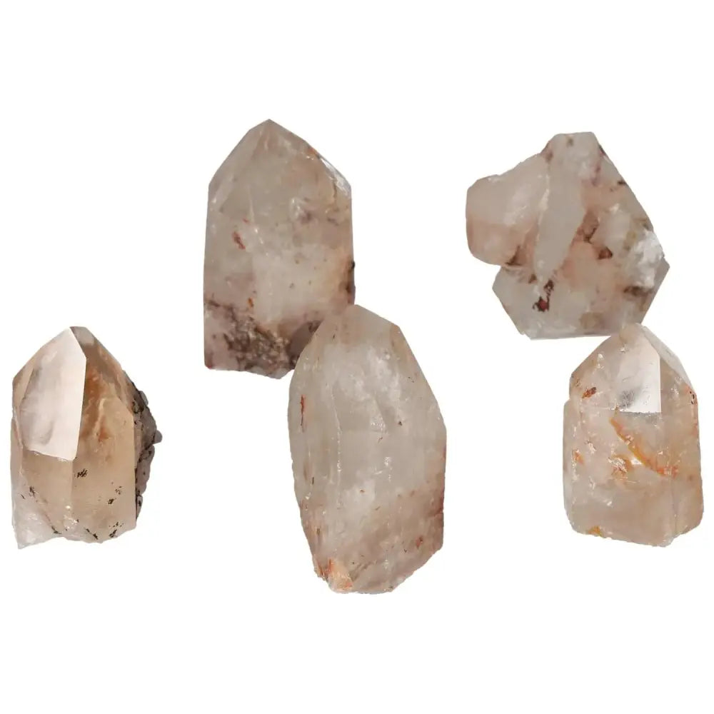 Five polished point quartz crystals with hematite, showcasing their natural elegance and metaphysical properties by Sylvia Crystals.