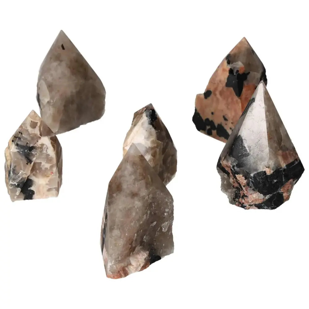 Polished point quartz with tourmaline, showcasing striking black inclusions and clear crystal structure, symbolizing luxury and energy.