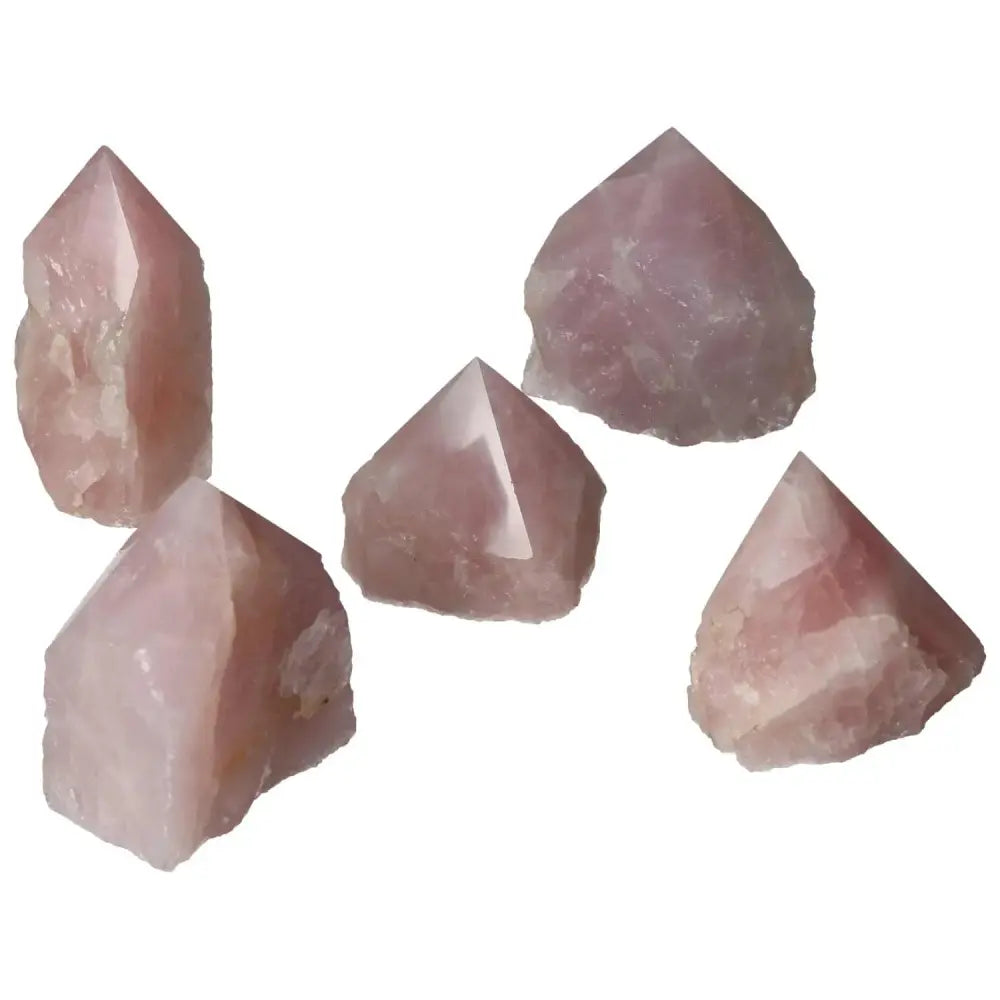 Collection of polished point rose quartz crystals showcasing luxury and healing properties from Sylvia Crystals.