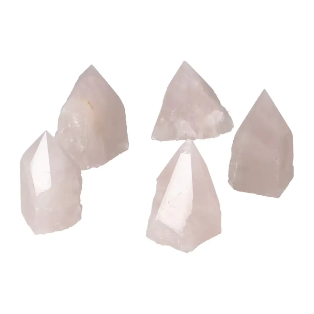 Cluster of polished point rose quartz crystals, showcasing Sylvia Crystals' handcrafted luxury and natural elegance.