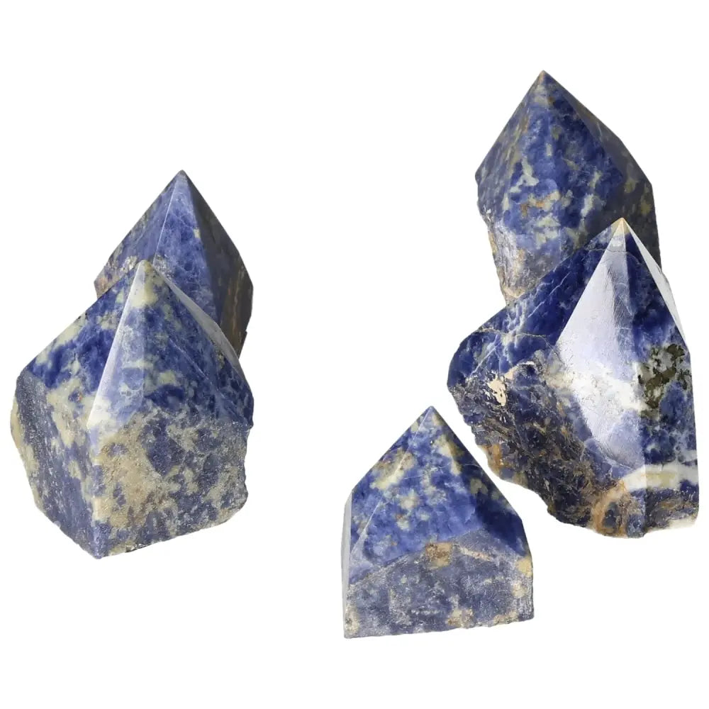 Polished point sodalite crystals in deep blue hues, enhancing mental clarity and creativity, from Sylvia Crystals.