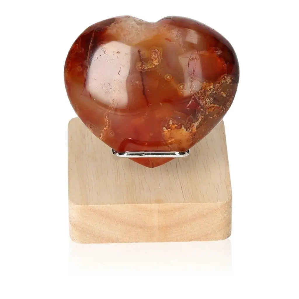 Polychrome Jasper Heart stone with vibrant earthy colors on a wooden stand, highlighting nature's artistry and desert jasper appeal.