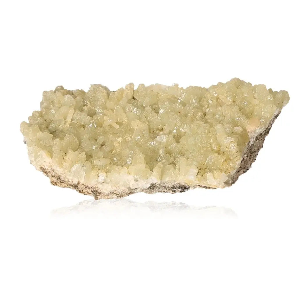 Prehnite druzy crystal showcasing pale green hues, known for promoting inner peace and spiritual growth.