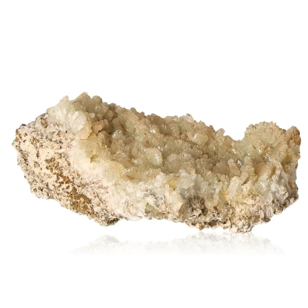 Prehnite druze gemstone with pale green-yellow crystals, known for soothing and spiritual growth properties.