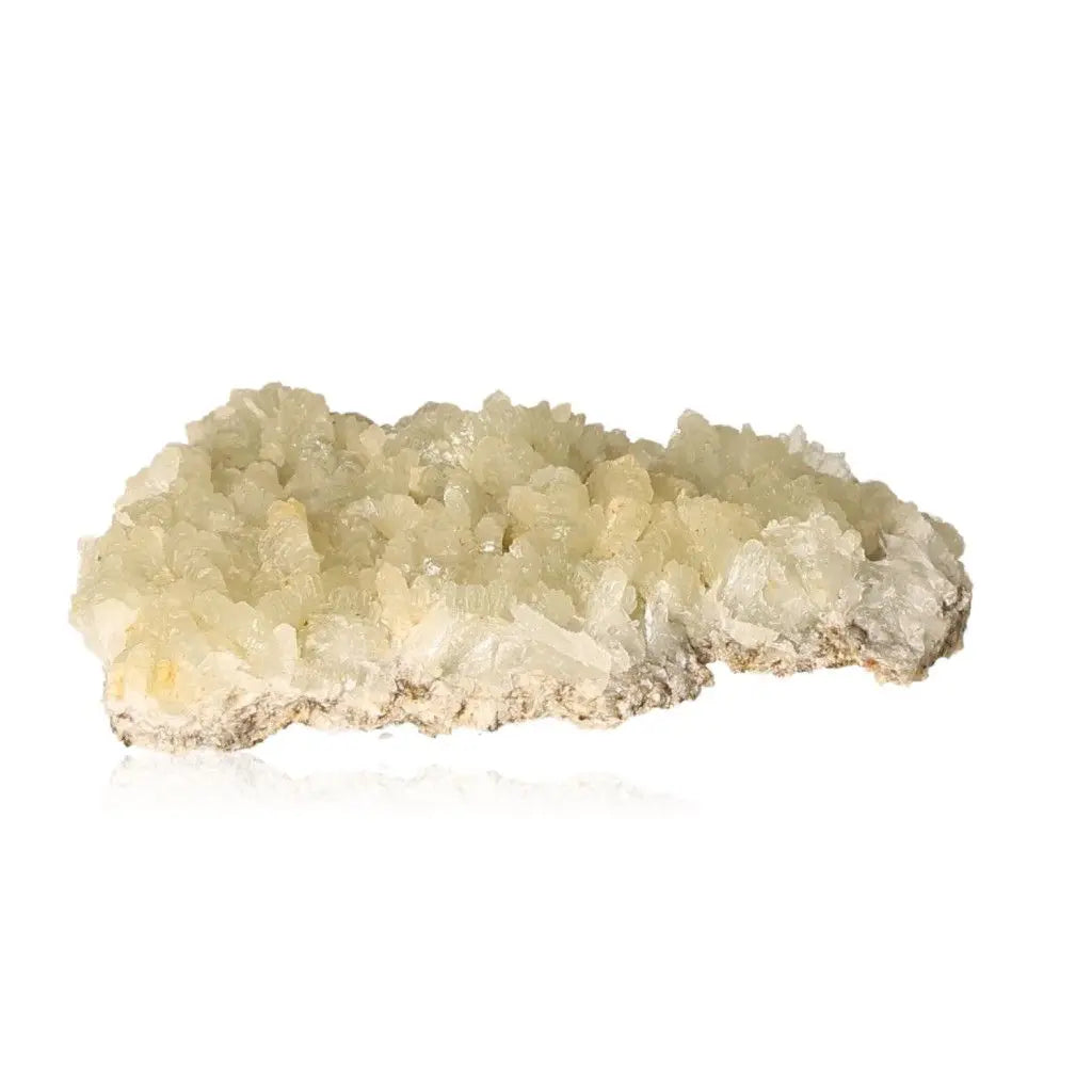 Translucent Prehnite Druze crystal with pale yellow-green hues, known for soothing energy and promoting spiritual growth.