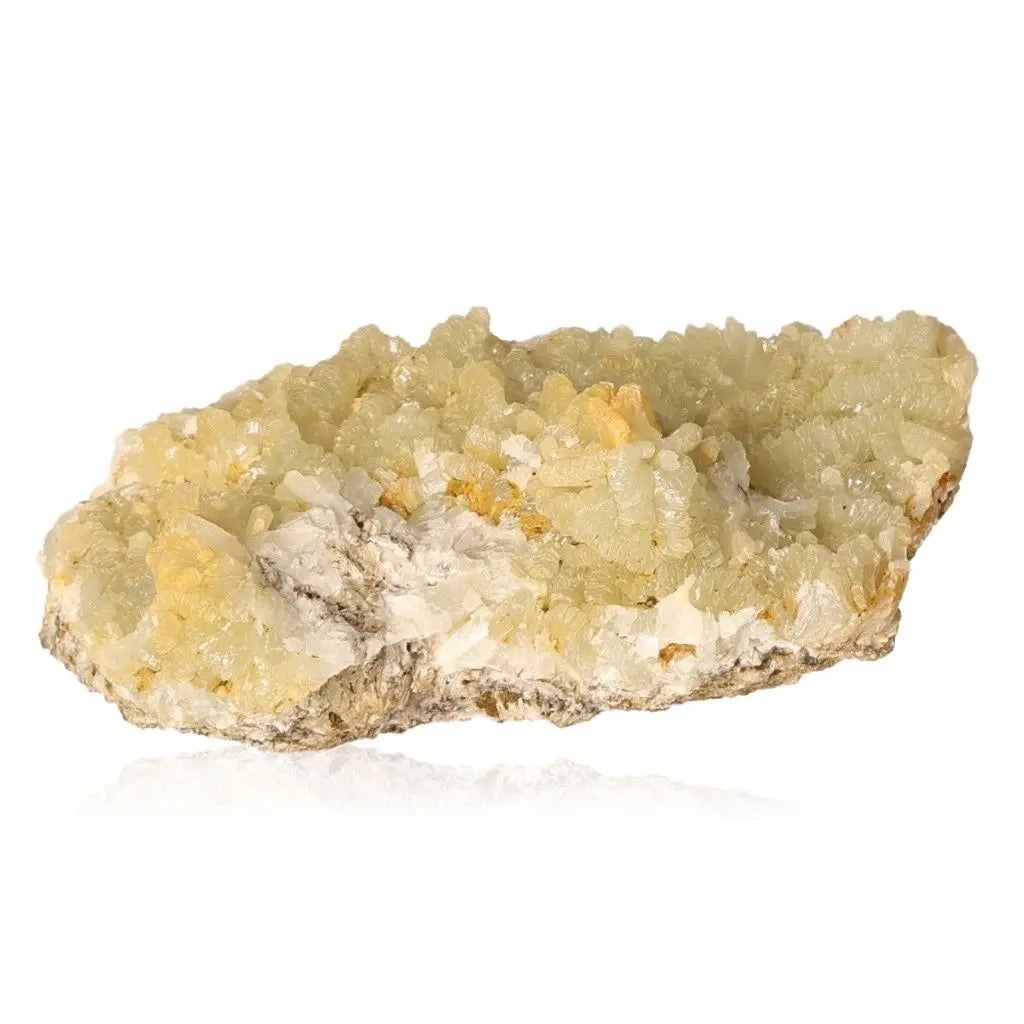 Prehnite Druze gemstone, calming pale green crystals on white rock, promotes spiritual growth and inner peace.