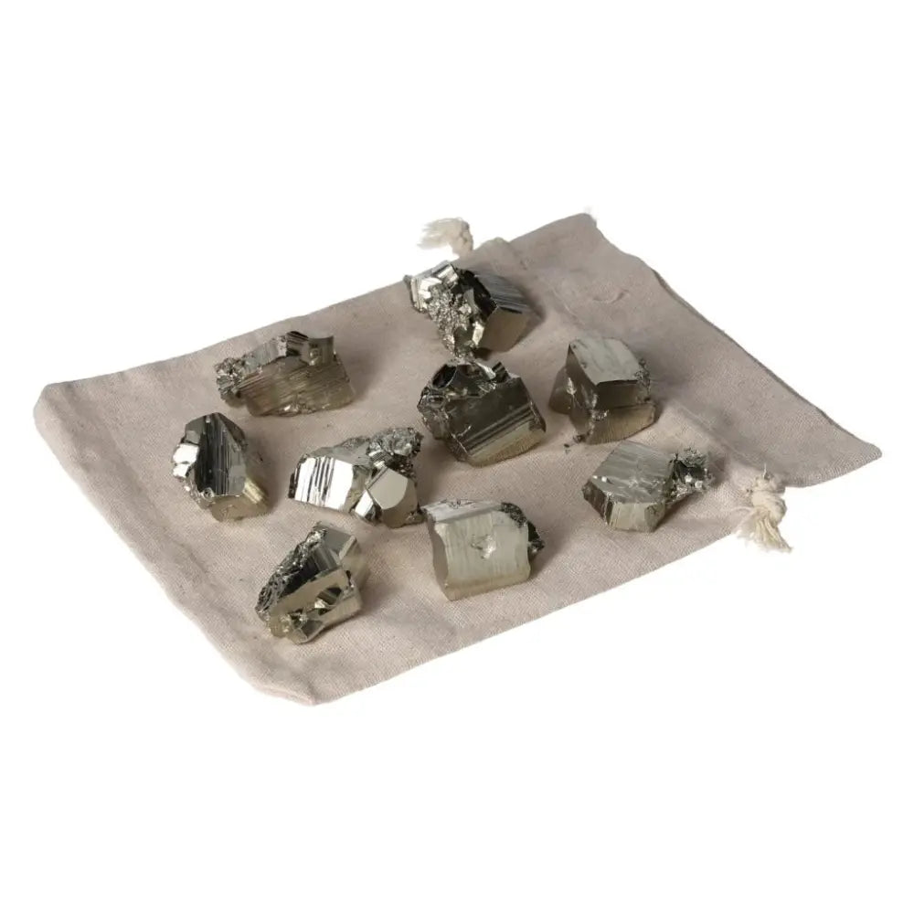 Polished pyrite cubes on a fabric cloth, showcasing golden luster and grounding energy for home décor or spiritual use.